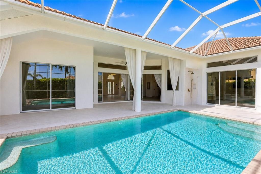 Screened patio with a rectangular swimming pool featuring integrated steps