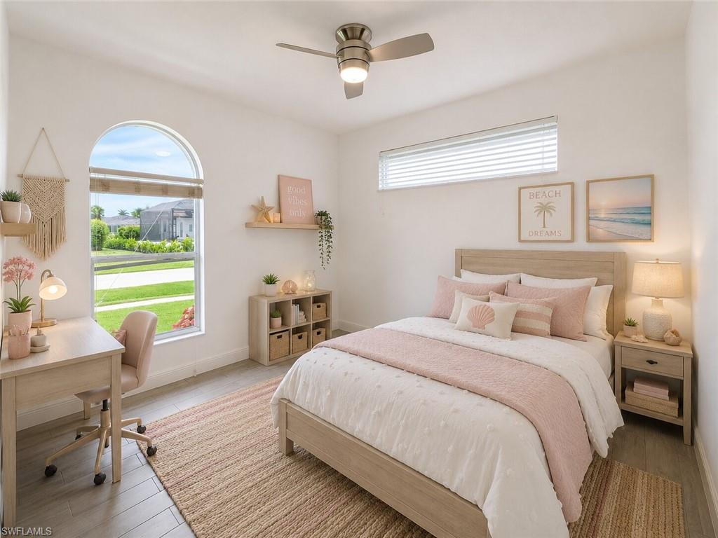 Light-filled room featuring a large arched window with a streetscape beyond
