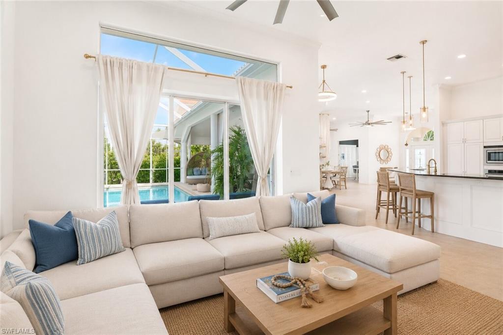Spacious living area featuring high ceilings and large glass sliders