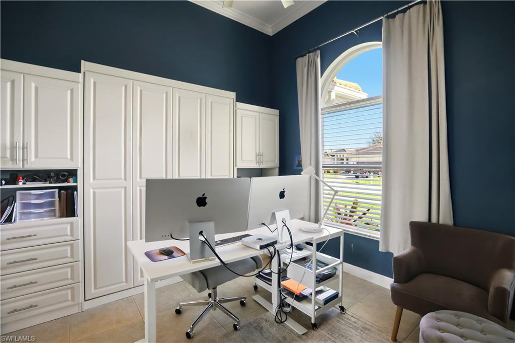 Office area with light tile patterned flooring and ornamental molding