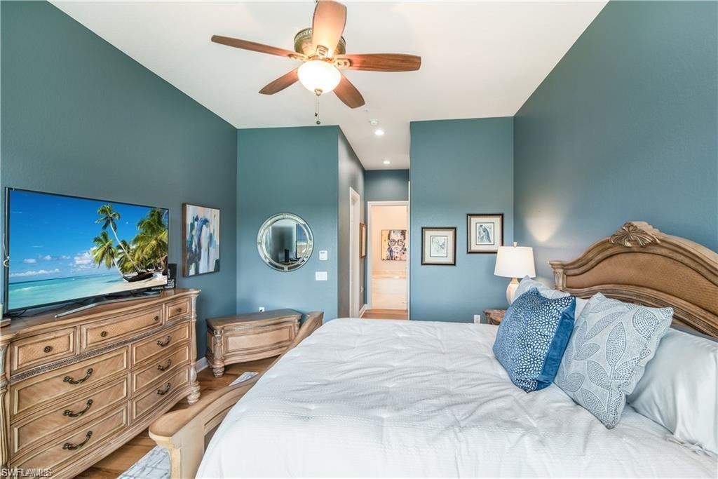 Bedroom with ceiling fan and light wood-type flooring