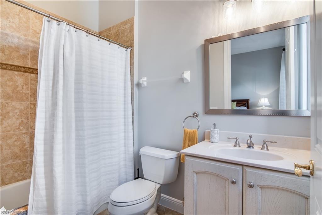 Full bathroom with shower / tub combo and vanity