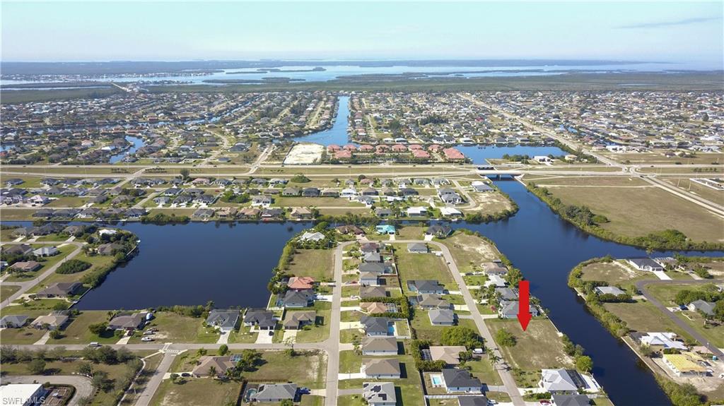 View of property location featuring a nearby body of water and nearby suburban area