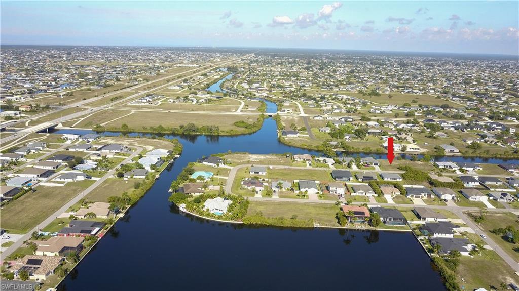 Aerial overview of property's location featuring nearby suburban area