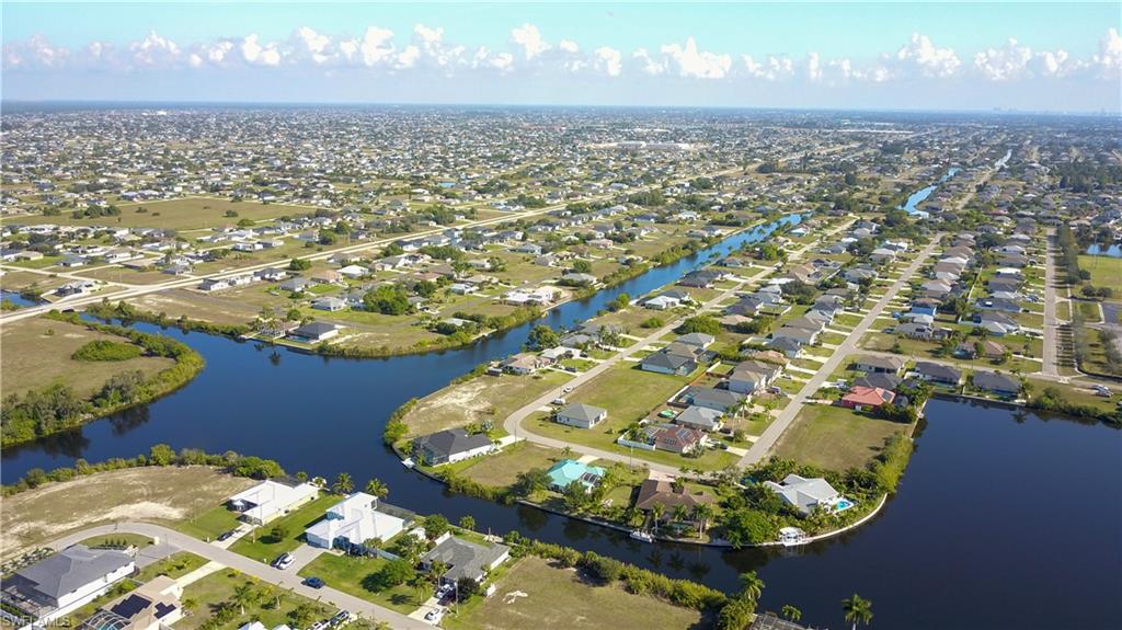 Aerial view of property's location featuring nearby suburban area and a nearby body of water
