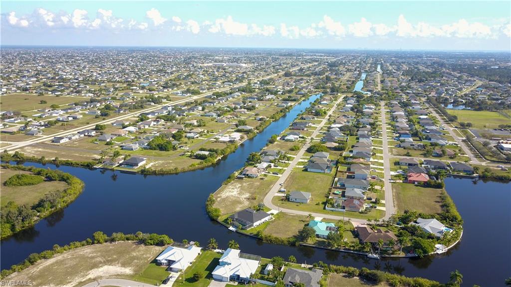 Aerial overview of property's location featuring nearby suburban area and a large body of water