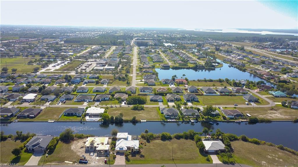 Aerial overview of property's location with a large body of water and nearby suburban area