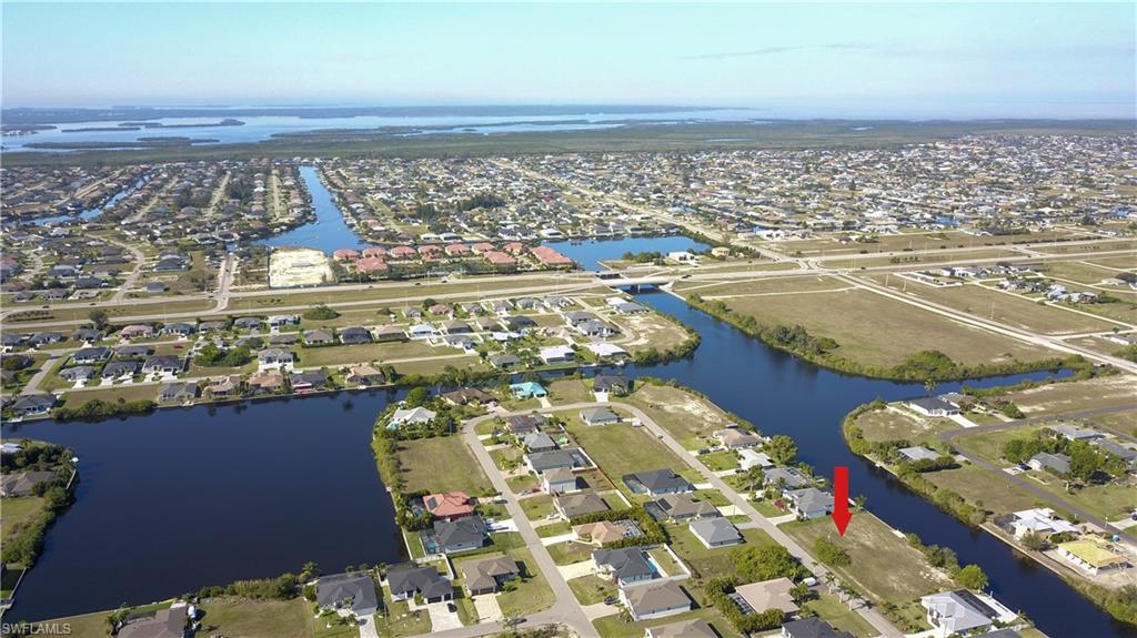 Aerial view of property's location featuring nearby suburban area and a large body of water