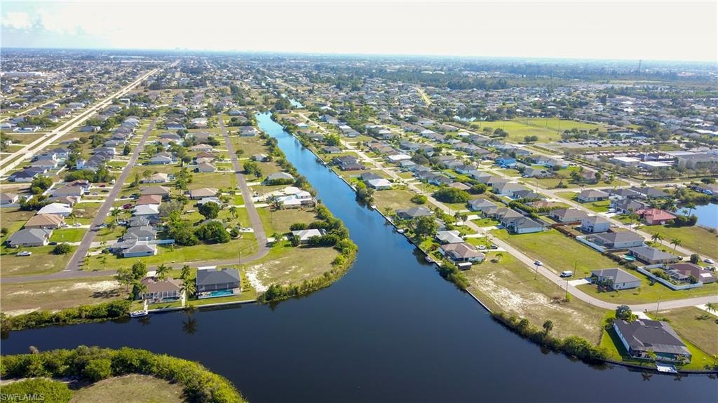 View of property location with nearby suburban area and a nearby body of water