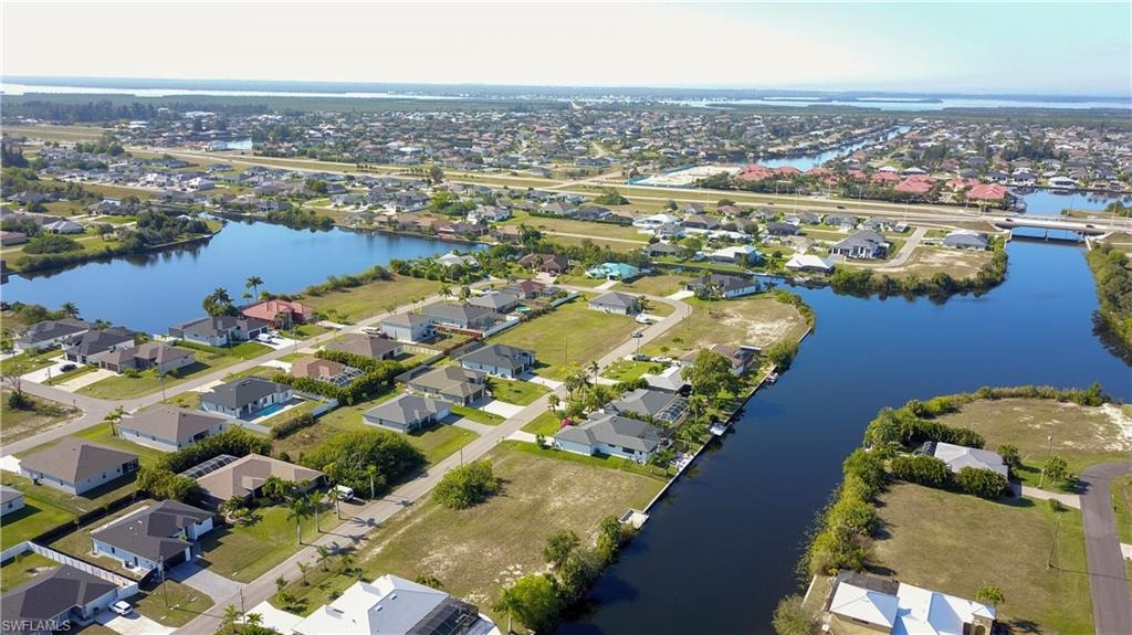 View of property location featuring a large body of water and nearby suburban area