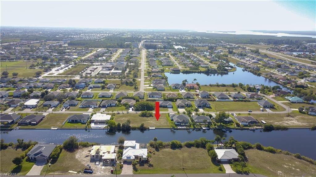 View of property location with a large body of water and nearby suburban area