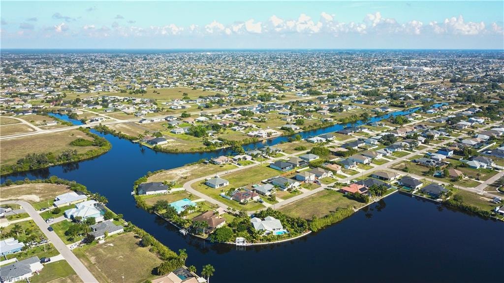 Aerial overview of property's location with nearby suburban area and a nearby body of water