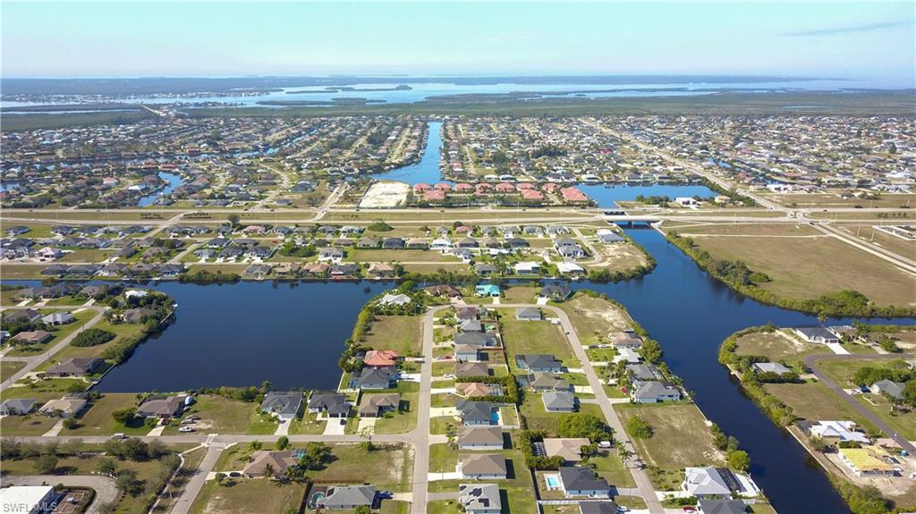 View of property location featuring a large body of water and nearby suburban area