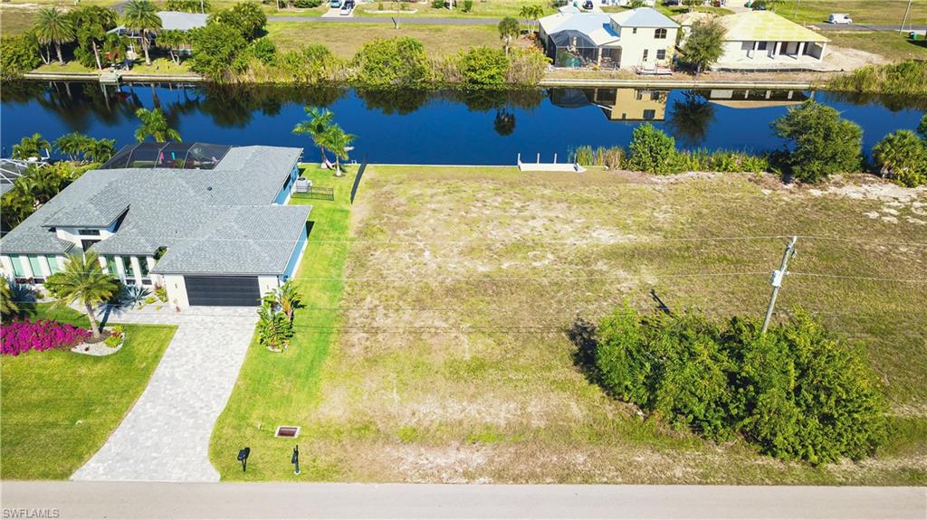 Aerial view of residential area featuring a large body of water