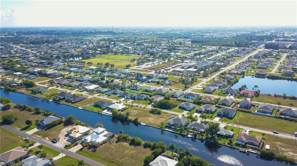 Aerial overview of property's location with nearby suburban area and a nearby body of water