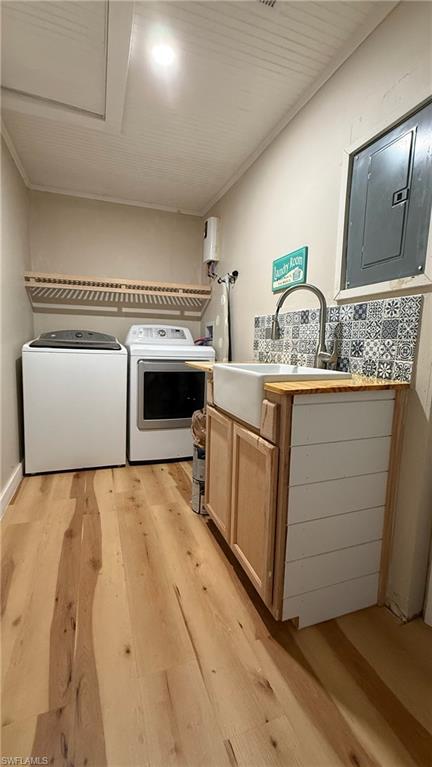 Laundry room featuring cabinet space, independent washer and dryer, l