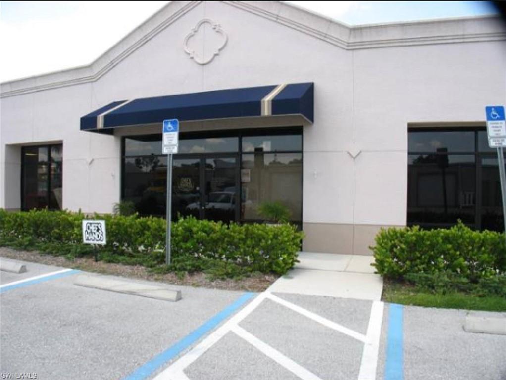 Entrance to property with uncovered parking and stucco siding