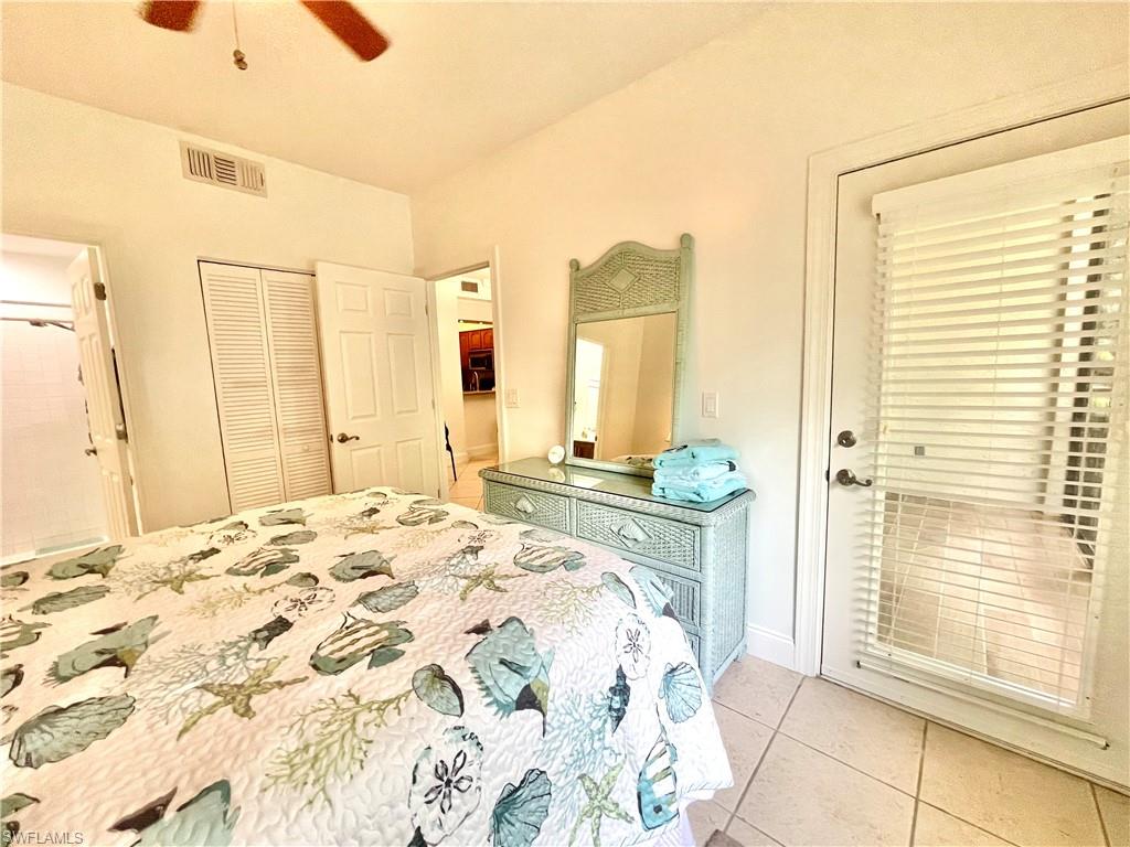 Bedroom featuring light tile patterned flooring, a closet, and ceiling fan