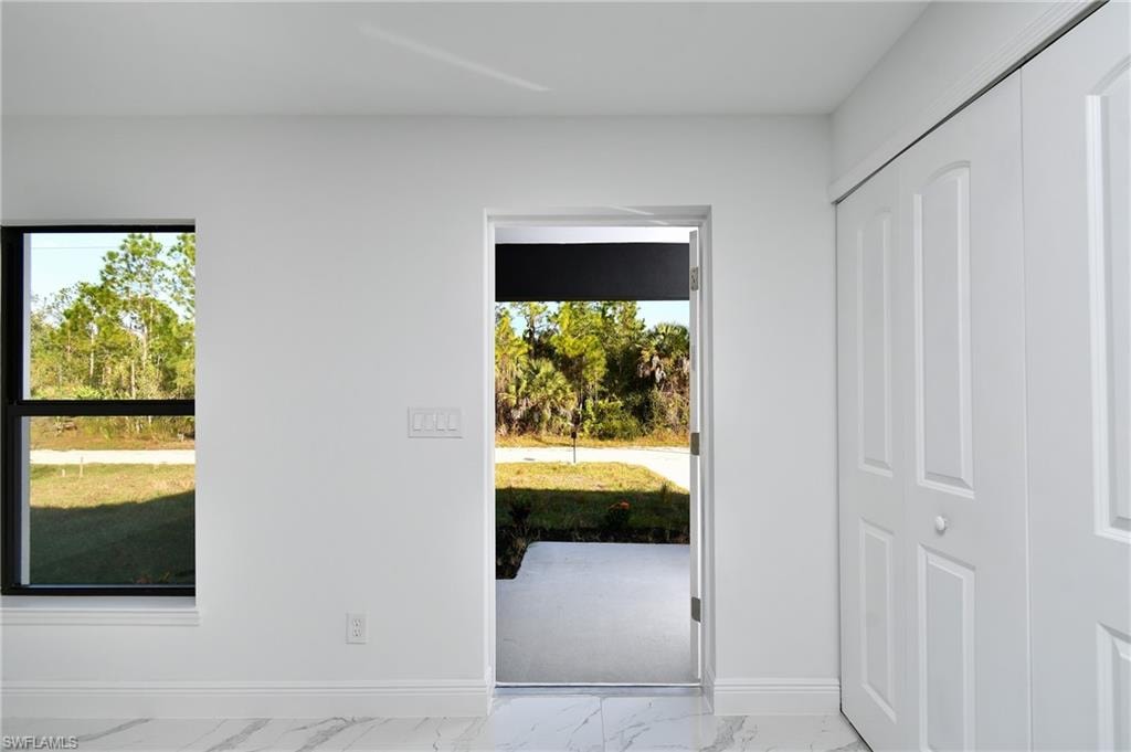 Doorway to outside featuring baseboards