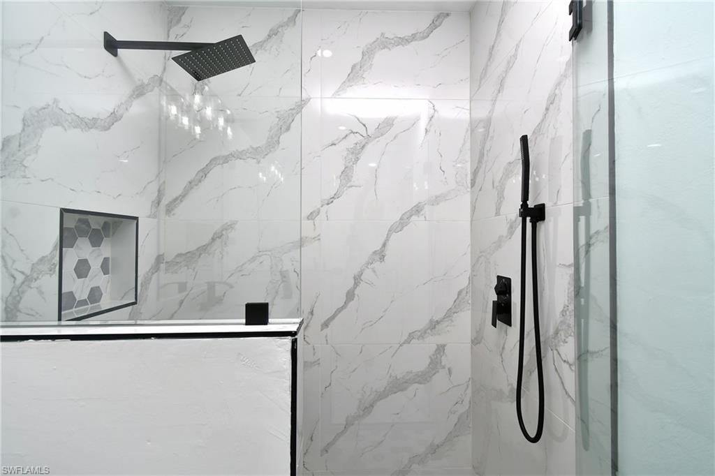 Bathroom featuring a marble finish shower