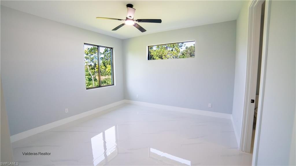 Spare room featuring baseboards and a ceiling fan