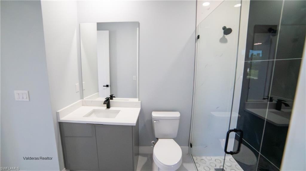 Bathroom featuring vanity and a shower stall