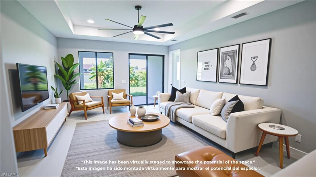 Living area with a tray ceiling, a ceiling fan, and recessed lighting