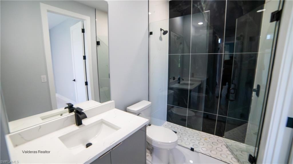 Full bath featuring vanity and a shower stall