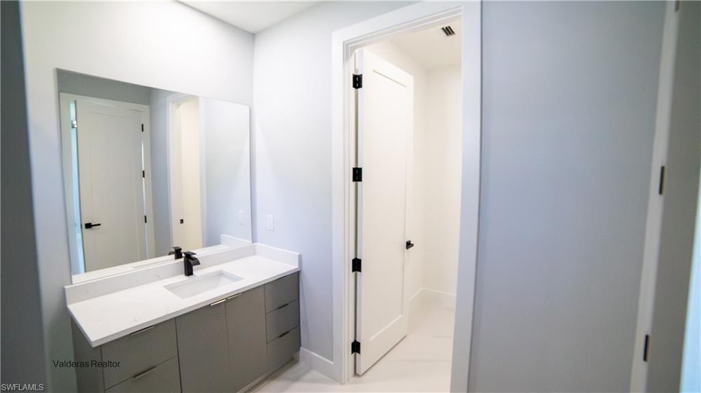 Half bath with vanity and baseboards