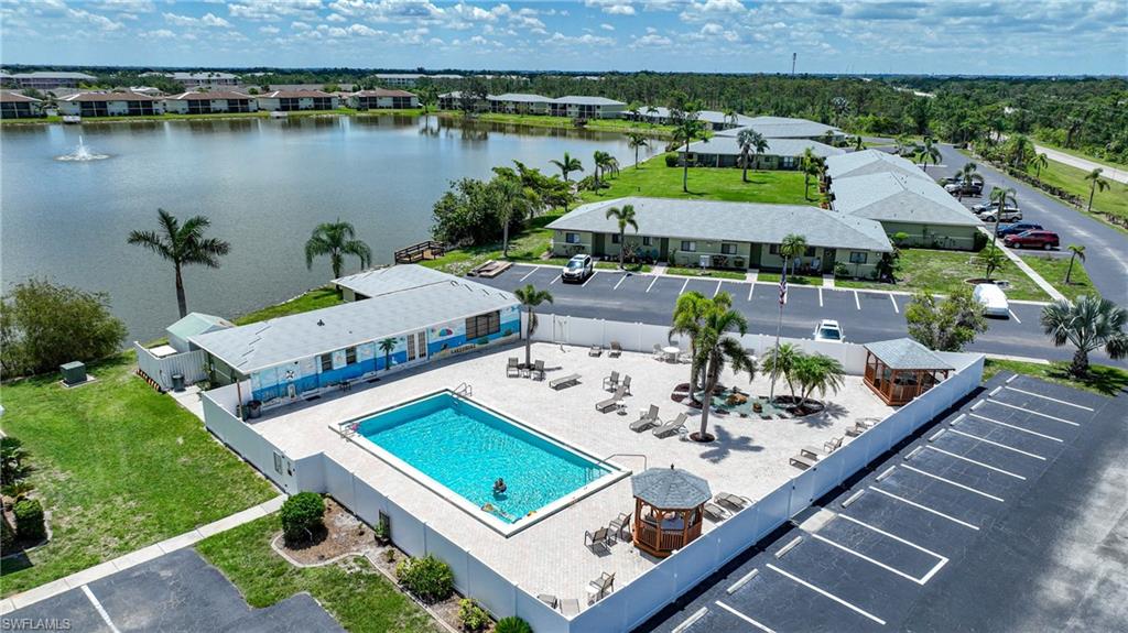 Drone / aerial view of a pool area and a large body of water