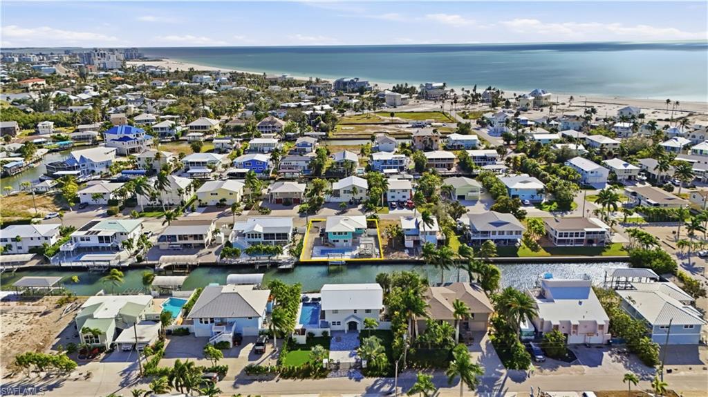 Aerial view of residential area featuring the nearby Gulf - Virtually Edited Image