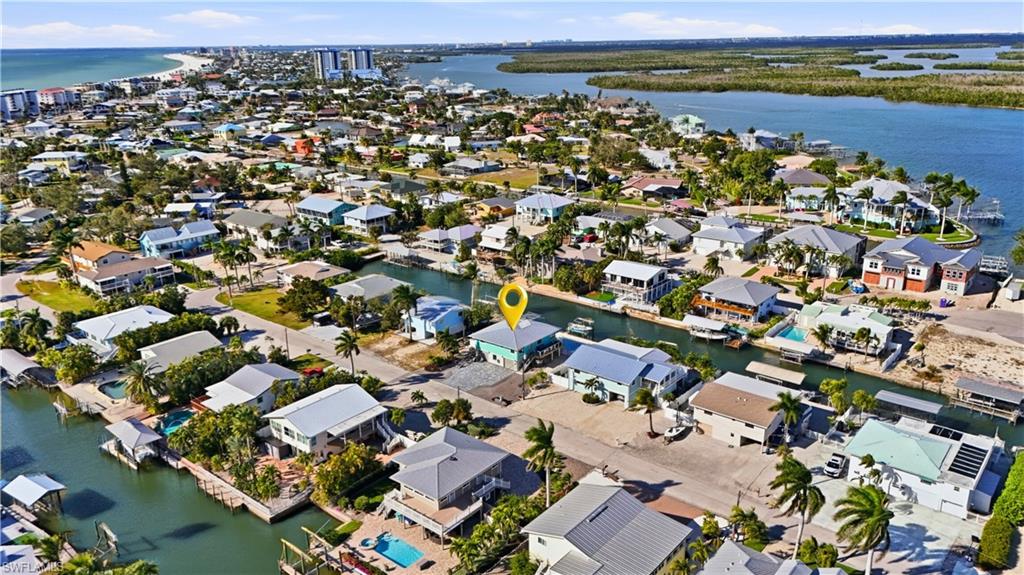 Aerial view of property's location with the nerby back bay and nearby suburban area - Virtually Edited Image