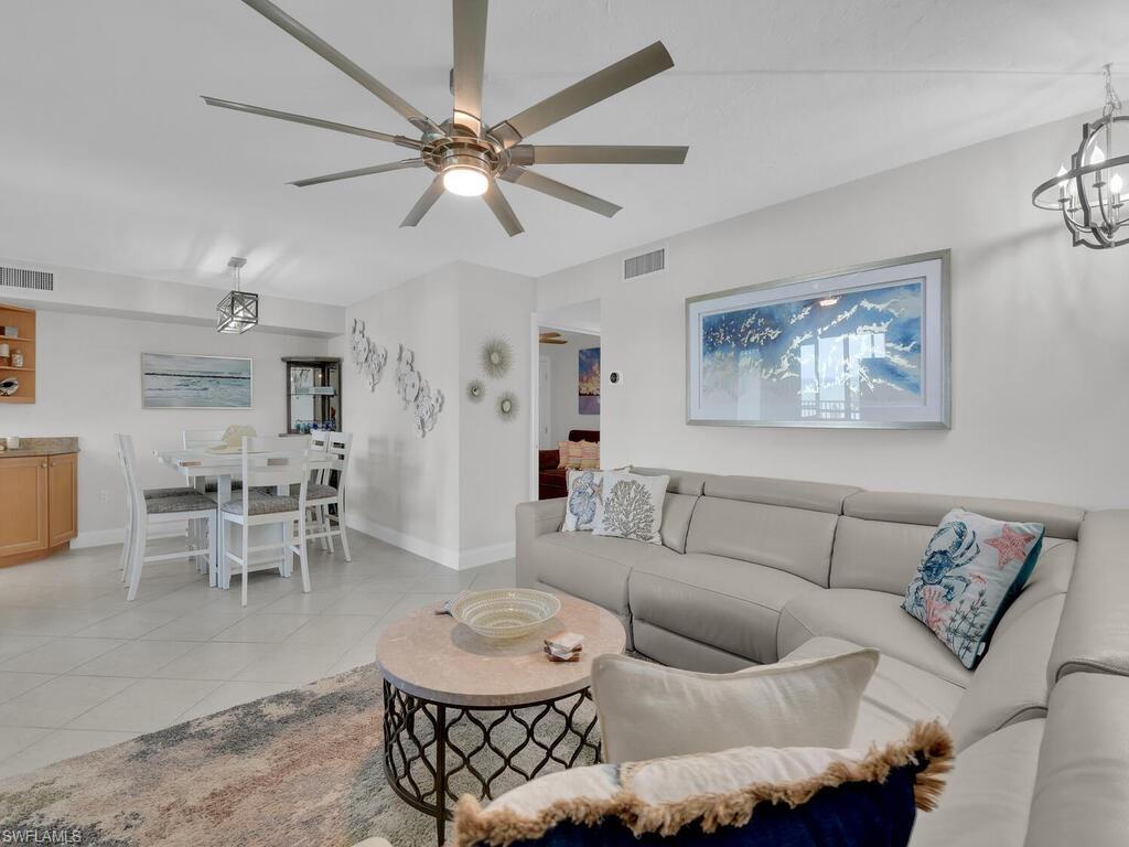 Living area featuring light tile patterned floors and a chandelier