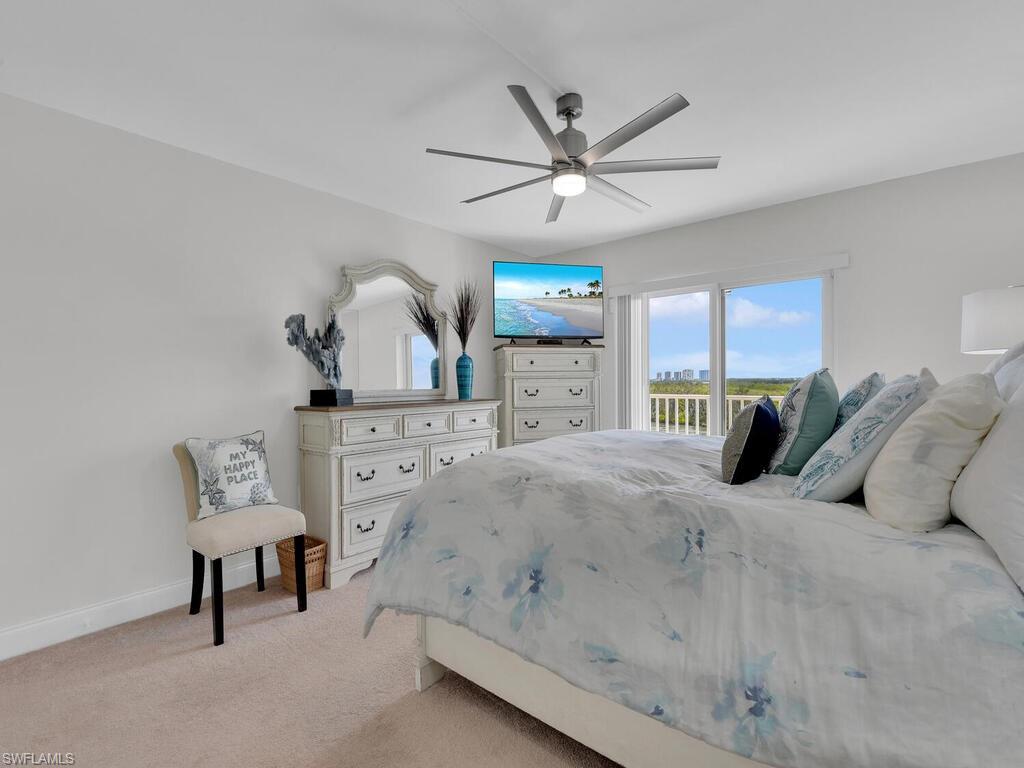 Bedroom featuring access to outside, light carpet, and a ceiling fan