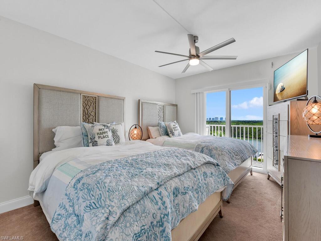 Carpeted bedroom with access to exterior and a ceiling fan