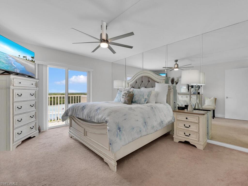Bedroom featuring access to exterior, light carpet, and ceiling fan
