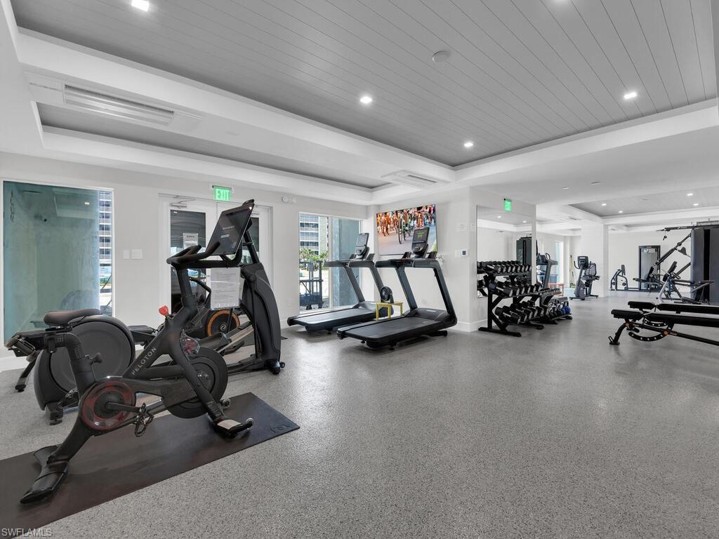 Exercise room with wooden ceiling and recessed lighting