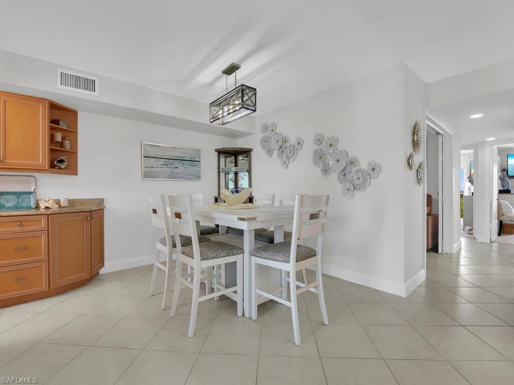 Dining area with baseboards and light tile patterned floors