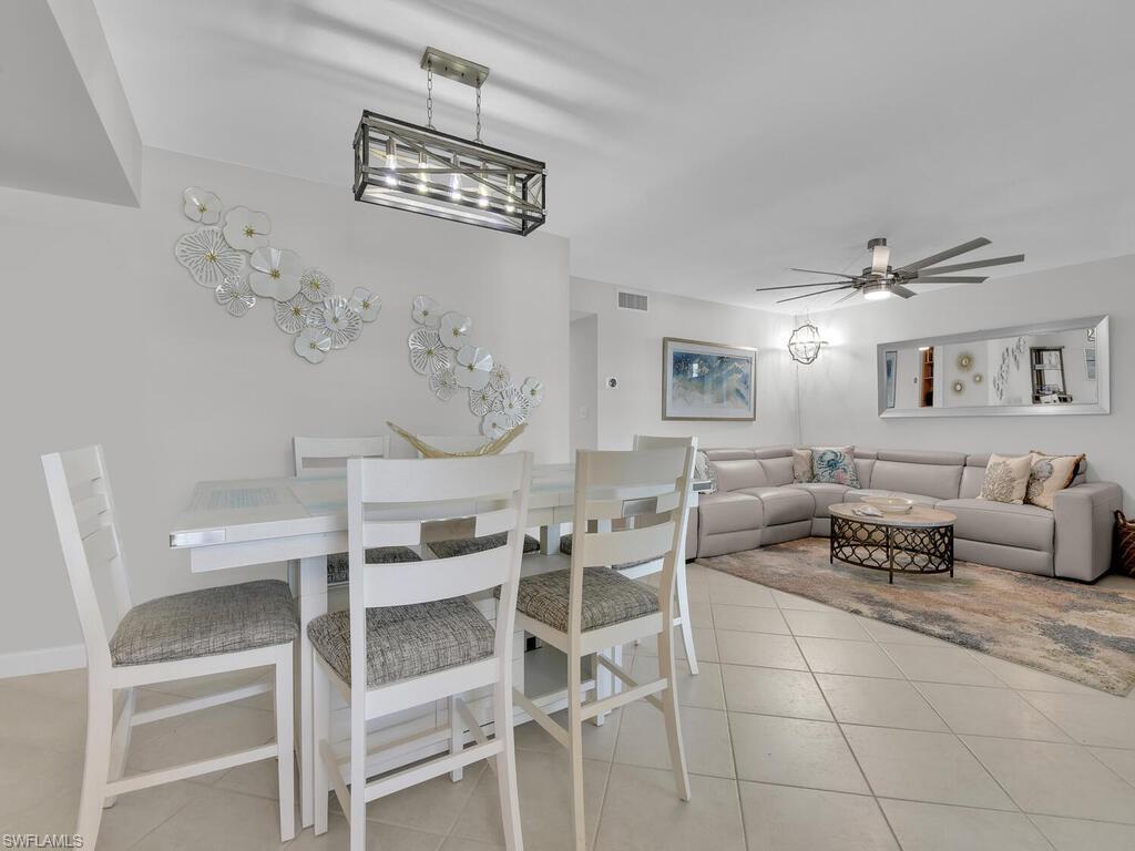 Dining area with light tile patterned flooring and ceiling fan