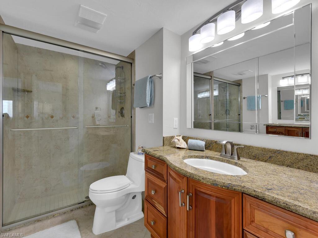 Full bathroom featuring vanity, a shower stall, and light tile patterned floors