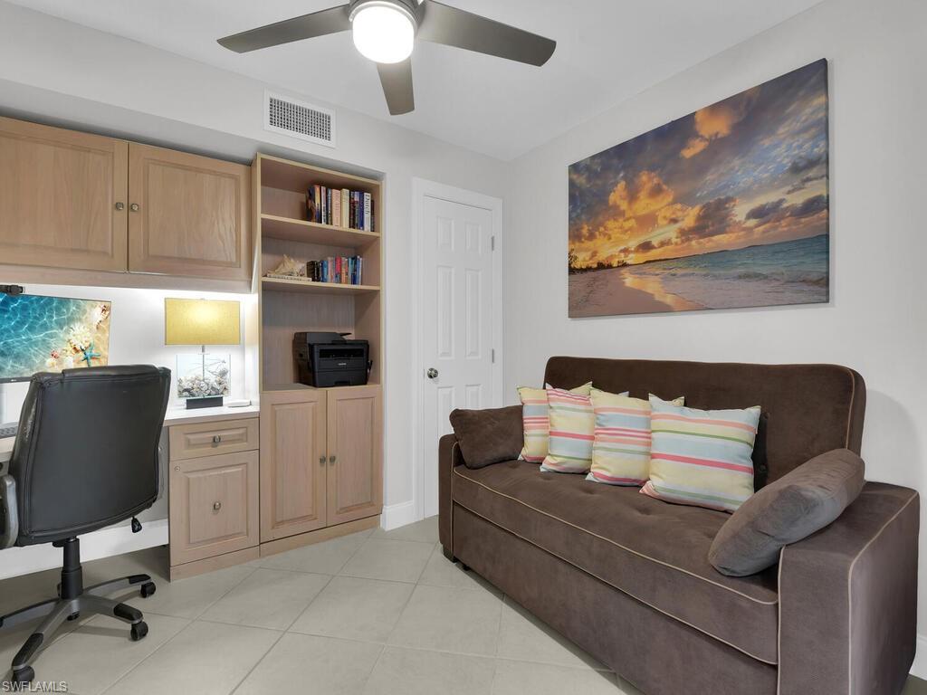 Office area with ceiling fan and light tile patterned floors