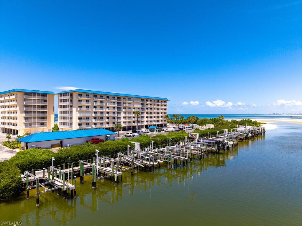 Water view featuring boat lift, a dock, and a marina