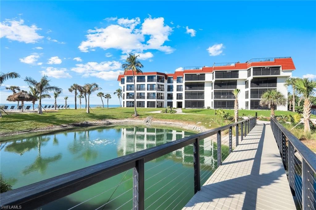 Dock area featuring a water view and a yard