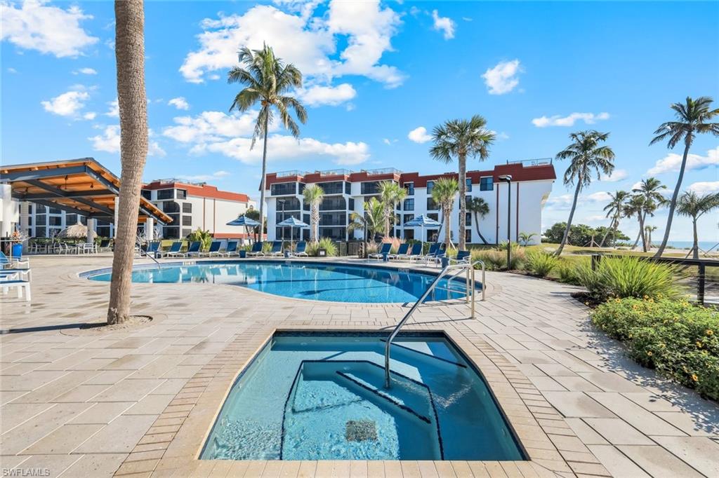 Community pool featuring a community hot tub and a patio area