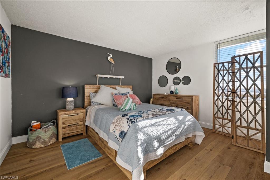 Bedroom featuring hardwood / wood-style flooring and a textured ceiling