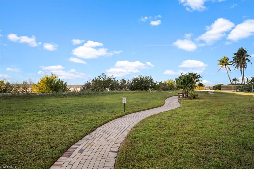 View of home's community with a yard