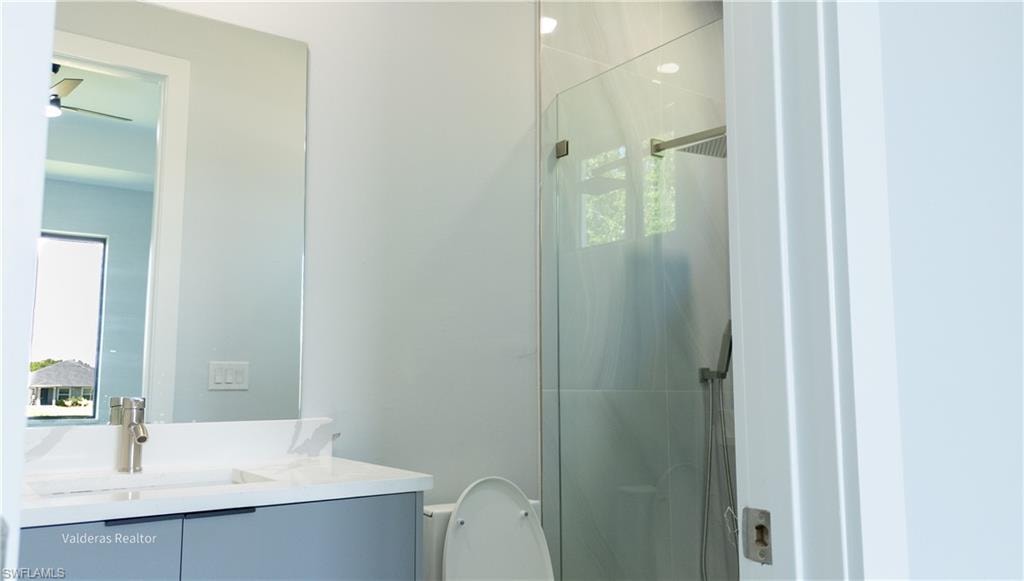 Full bathroom with vanity and a stall shower