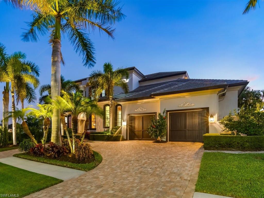 Mediterranean / spanish house featuring decorative driveway, an attached garage, stucco siding, and a front yard