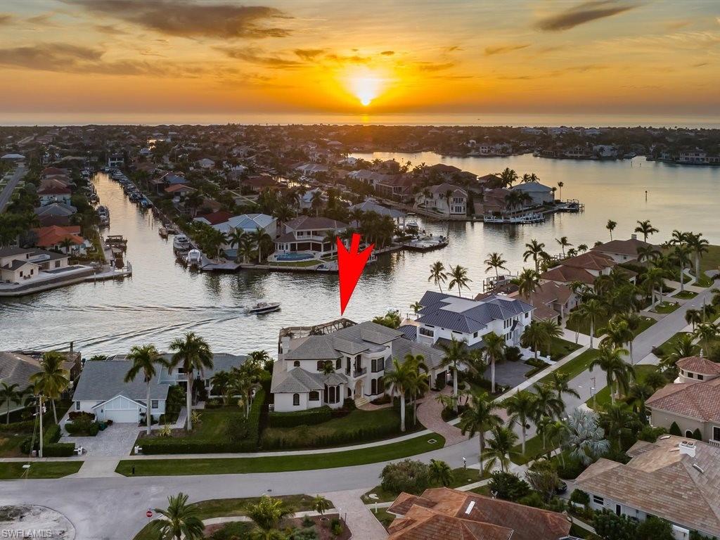Aerial view at dusk of a water view and a residential view