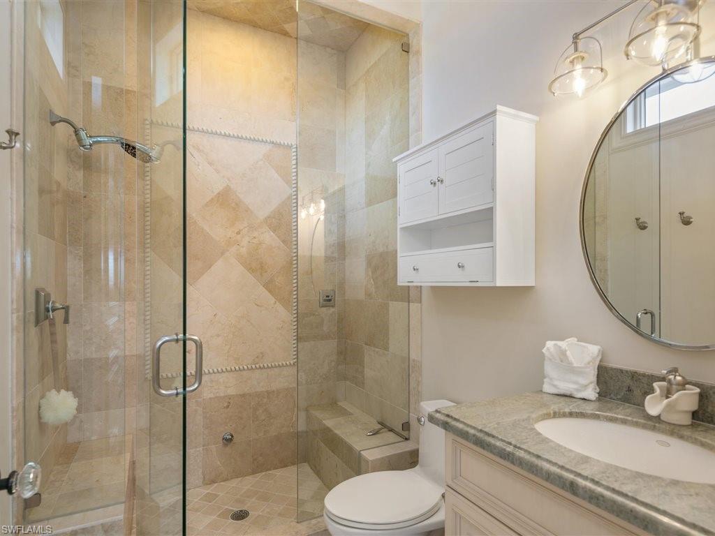 Full bath with a shower stall and vanity